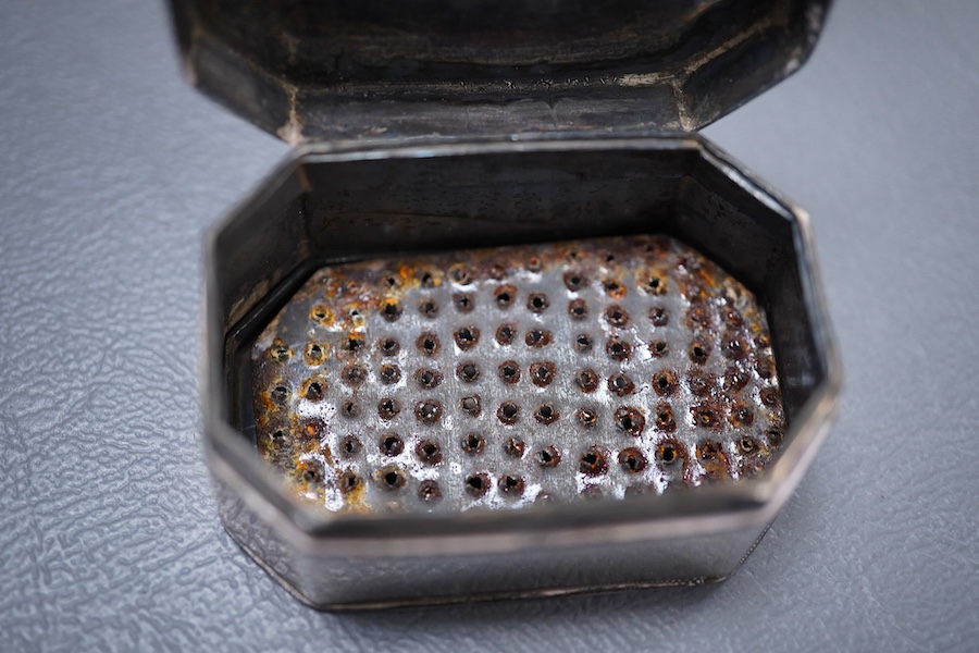 A George III silver octagonal nutmeg grater by Phipps & Robinson, London, 1810, 46mm(a.f.), together with a George III silver pedestal pepperette, by Alice & George Burroughs, London, 1808, 70mm.
